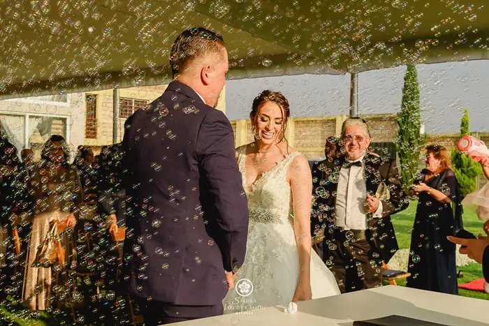 Novios celebrando entre burbujas al terminar su ceremonia en el jardín de Sakura Metepec